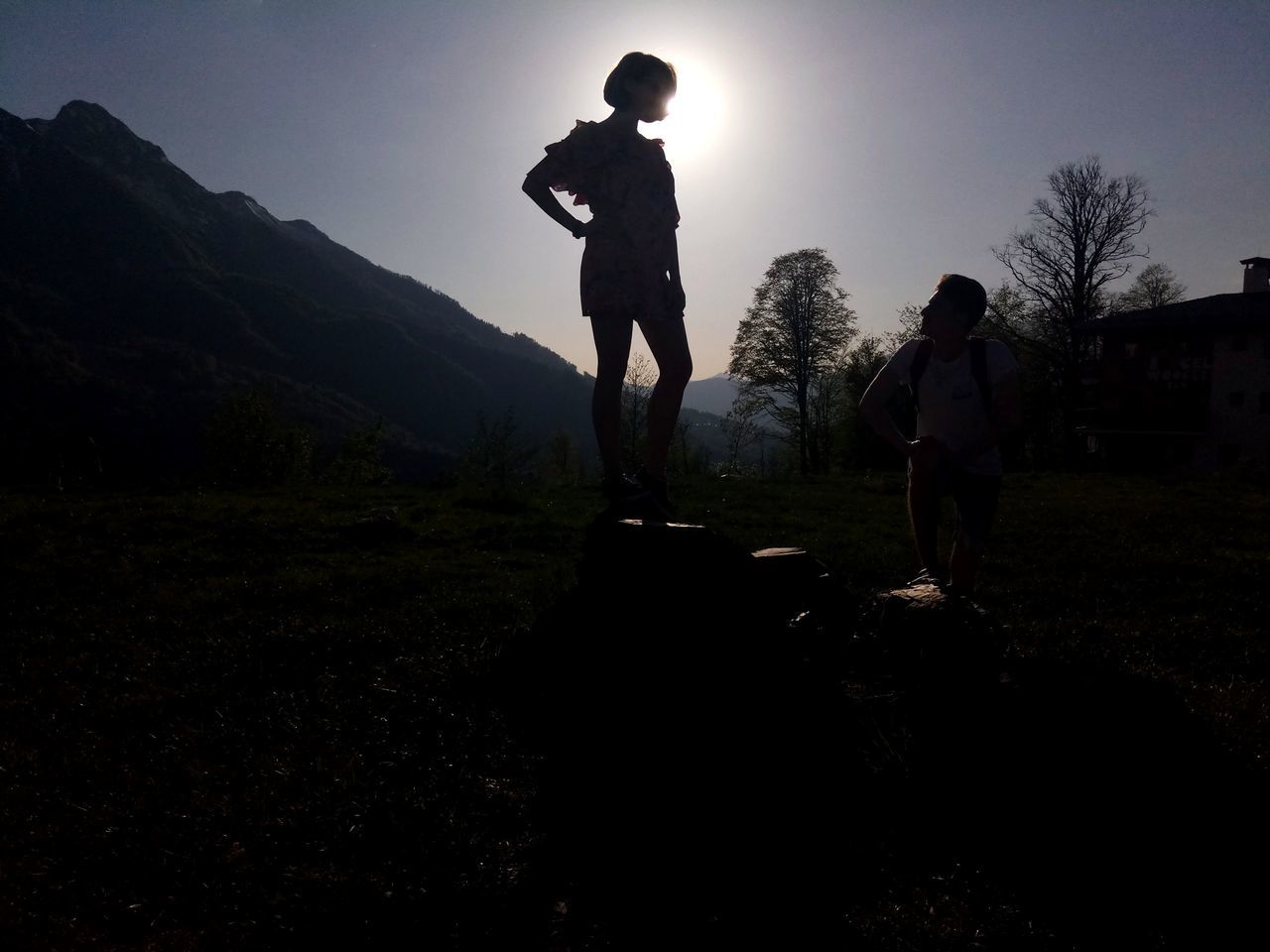 sky, men, real people, lifestyles, nature, leisure activity, full length, mountain, plant, standing, people, silhouette, grass, beauty in nature, land, tree, day, field, rear view, outdoors