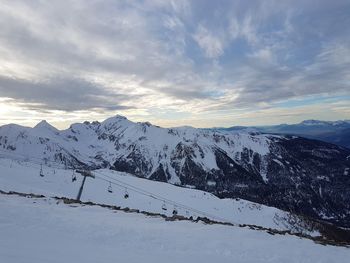 Scenic view of snowcapped mountains against sky