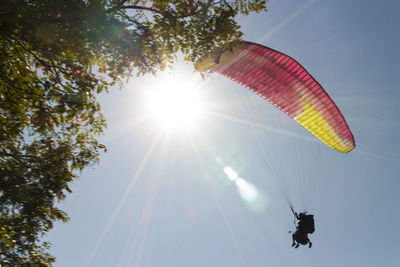 Low angle view of silhouette people against sky on sunny day