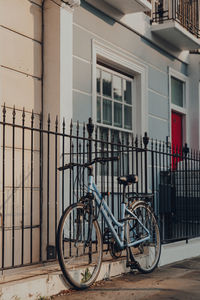 Bicycle on footpath against building