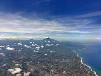 Scenic view of sea and mountain against sky.