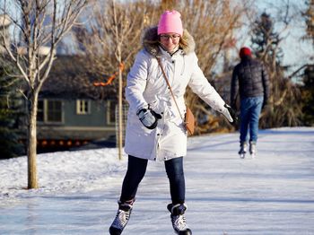 Full length of woman skating on snowy land