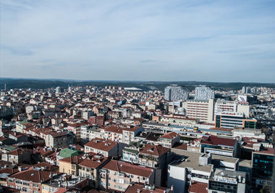 Aerial view of cityscape by sea against sky