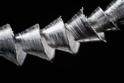 Close-up of metallic object against black background
