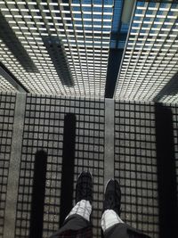 Low section of woman standing on tiled floor