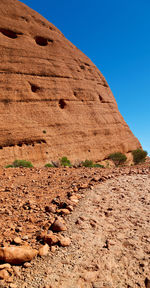 View of rock formations in desert against clear blue sky