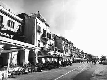 Street amidst buildings in city against sky