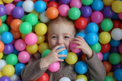 Portrait of cute girl playing with multi colored balls