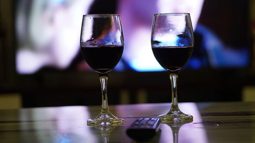 Close-up of wine glasses on table