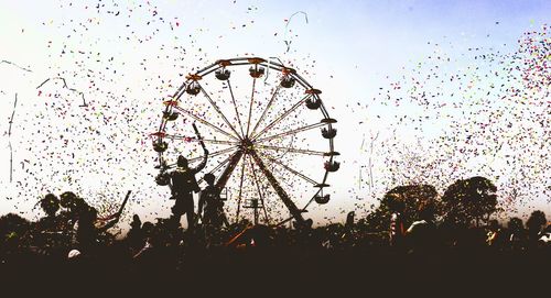 Low angle view of ferris wheel against sky