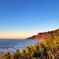 Scenic view of sea against clear blue sky