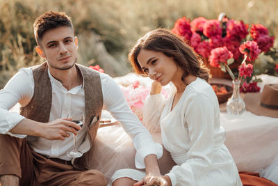 Young couple sitting outdoors