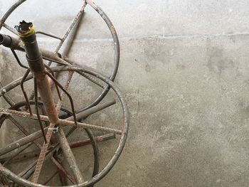 High angle view of abandoned bicycle on wall