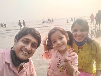 Portrait of smiling young people on beach