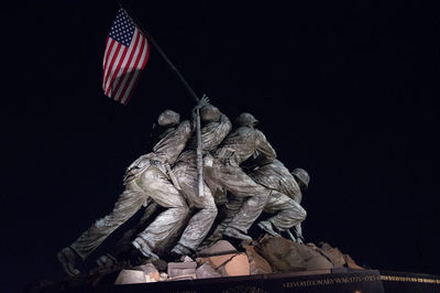 Low angle view of statue against sky at night