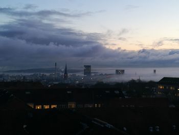 High angle view of illuminated city against sky at sunset