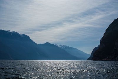 Scenic view of sea and mountains against sky