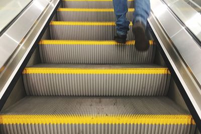 Low section of man on escalator