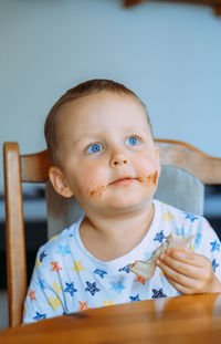 Portrait of cute baby boy sitting on table