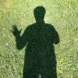 Shadow of person on grass