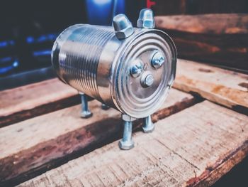 Close-up of machine part on wooden table