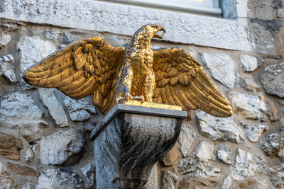 Sculpture of a golden eagle on a building in stolberg, eifel, germany