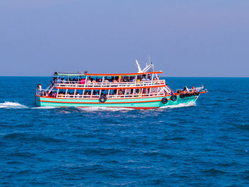 Boat sailing in sea against clear sky