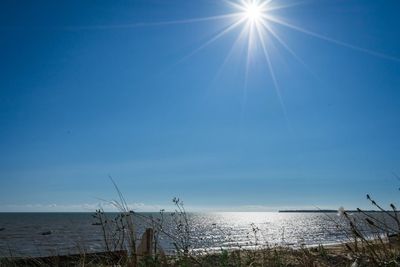 Scenic view of sea against sky on sunny day