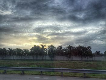 Scenic view of field against cloudy sky