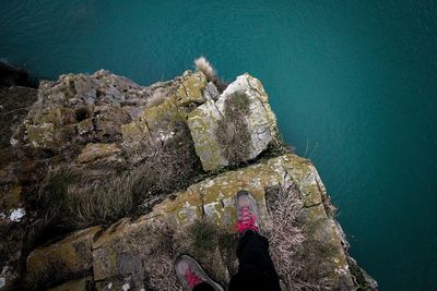 High angle view of woman on rock at sea