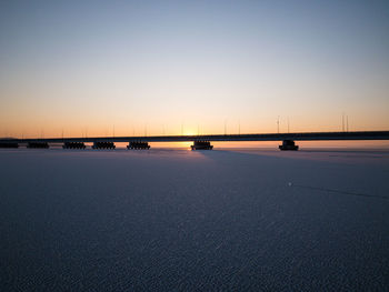 Scenic view of sea against clear sky at sunset