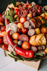 Delicious edible bouquet of sausage, tomatoes, cheese. gift for man.