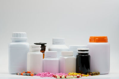 Close-up of wine bottles against white background