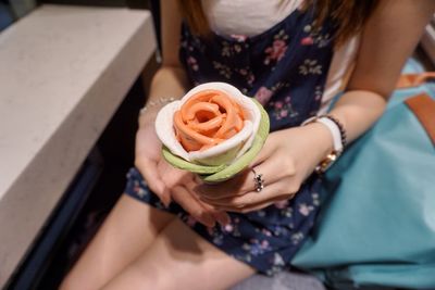 Midsection of woman holding rose bouquet