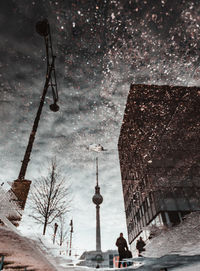 Reflection of fernsehturm on puddle