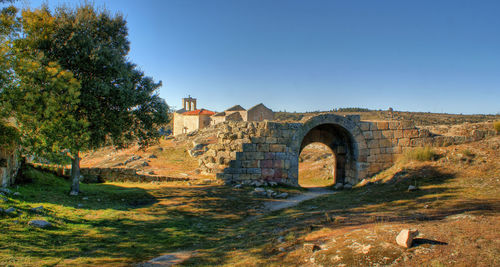 Old ruin building against clear blue sky