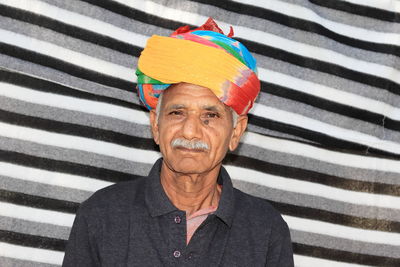 Close-up of an elderly indian farmer or gardener wearing and a colored turban on his head 