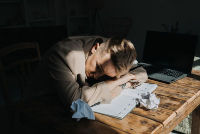 Burnout, emotional problems, depression concept. sad tired depressed woman lying on the table among