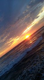 Scenic view of beach against sky during sunset