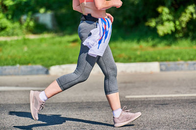 Low section of woman on footpath