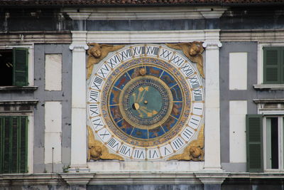 Low angle view of clock tower against building