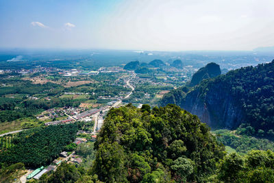 Aerial view of green landscape and sea against sky