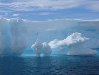 Ice floating on sea against sky