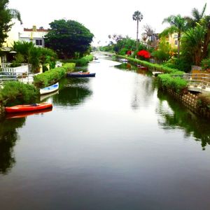 Boats in river with buildings in background