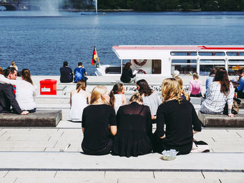 Rear view of people enjoying at the beach