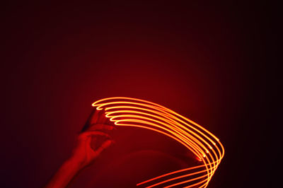 Close-up of illuminated light bulb against black background