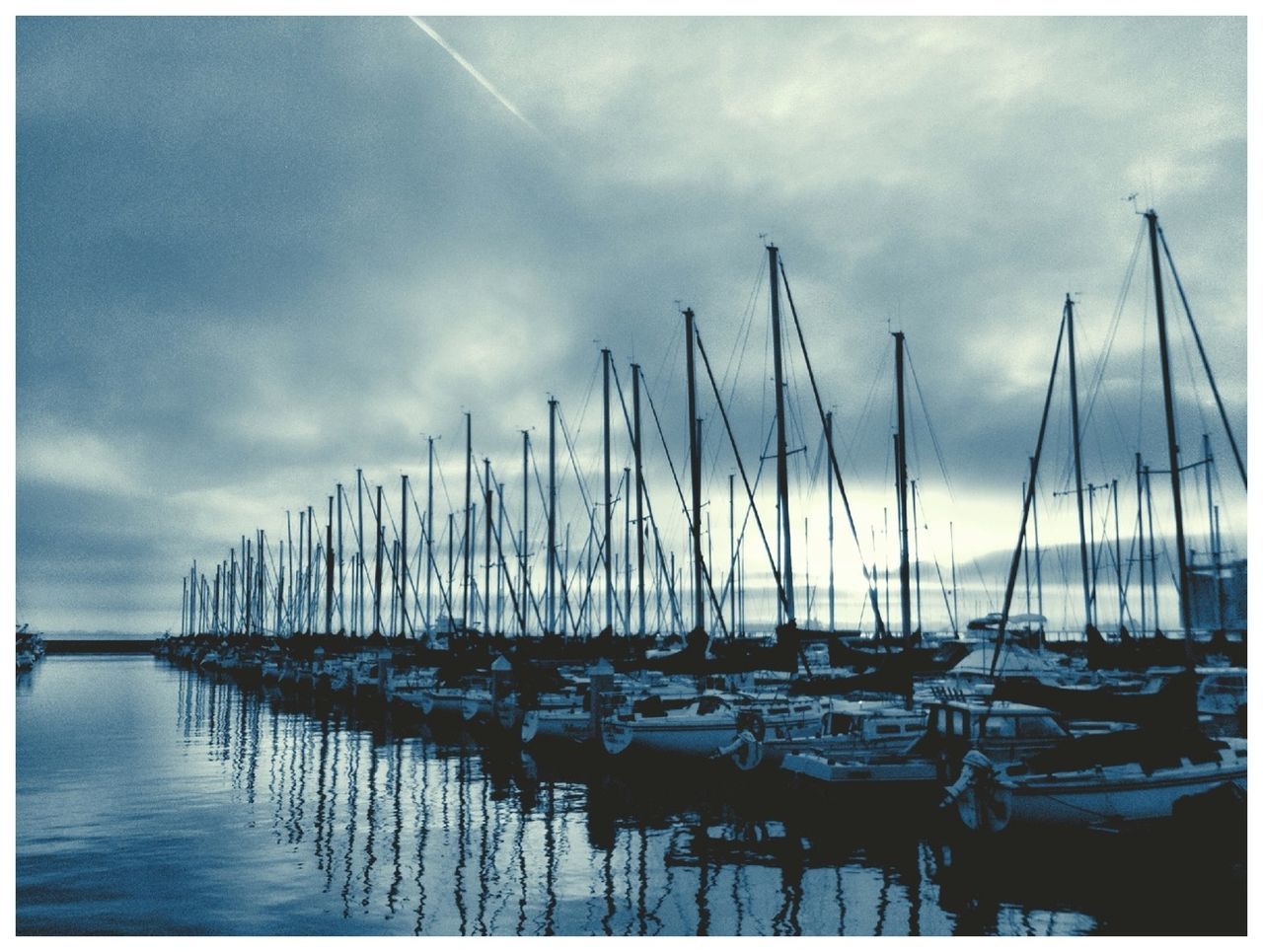 sea, water, sky, transfer print, nautical vessel, moored, auto post production filter, boat, transportation, horizon over water, cloud - sky, harbor, in a row, mode of transport, cloud, tranquility, ocean, pier, tranquil scene, nature