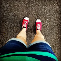 Low section of person standing on tiled floor