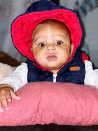 Portrait of cute baby girl in bed