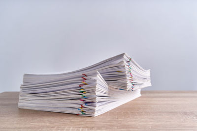 Close-up of books on table against white background